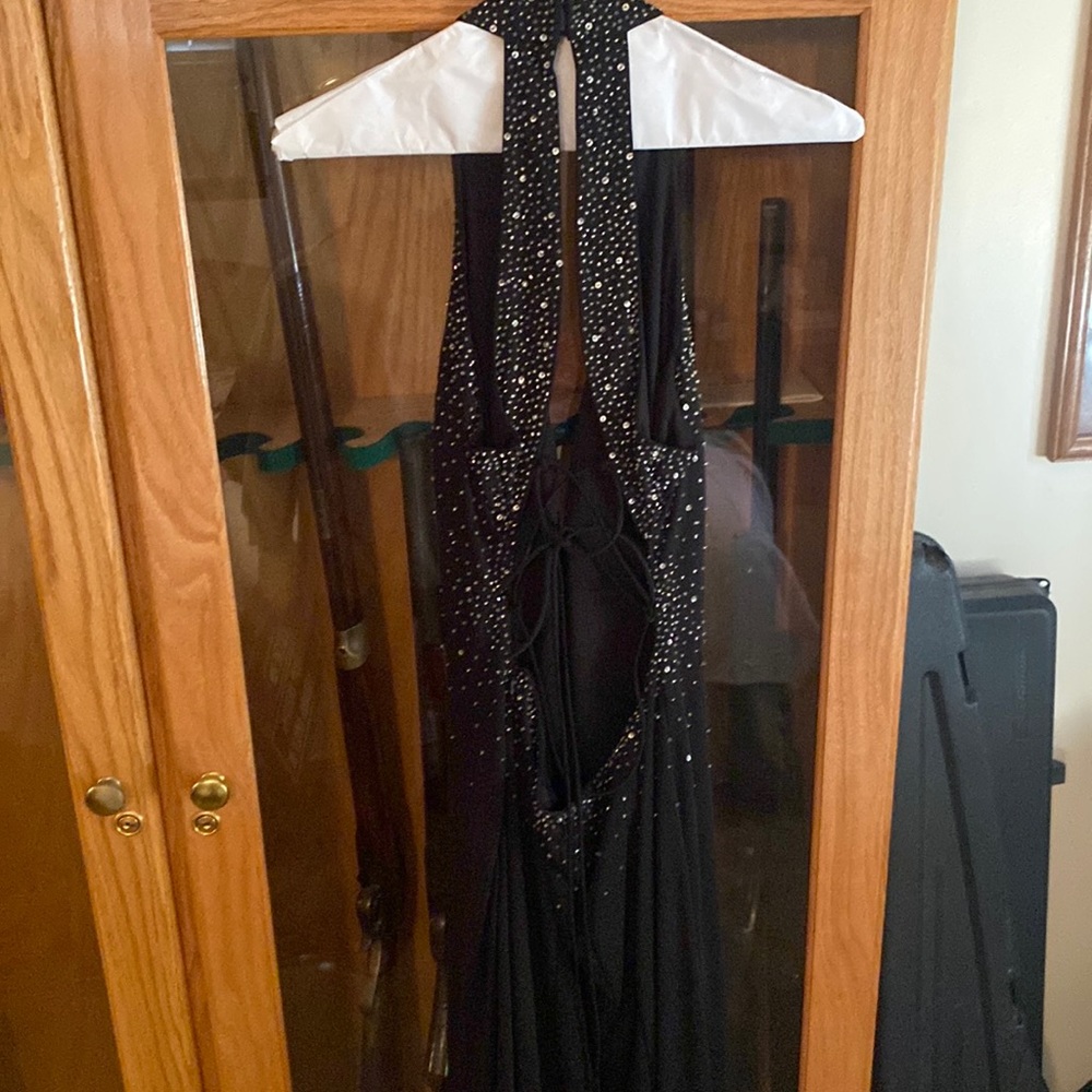 Black low cut, open back formal dress with sequins
